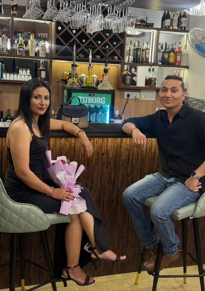 A couple celebrating at the well-stocked Aura bar