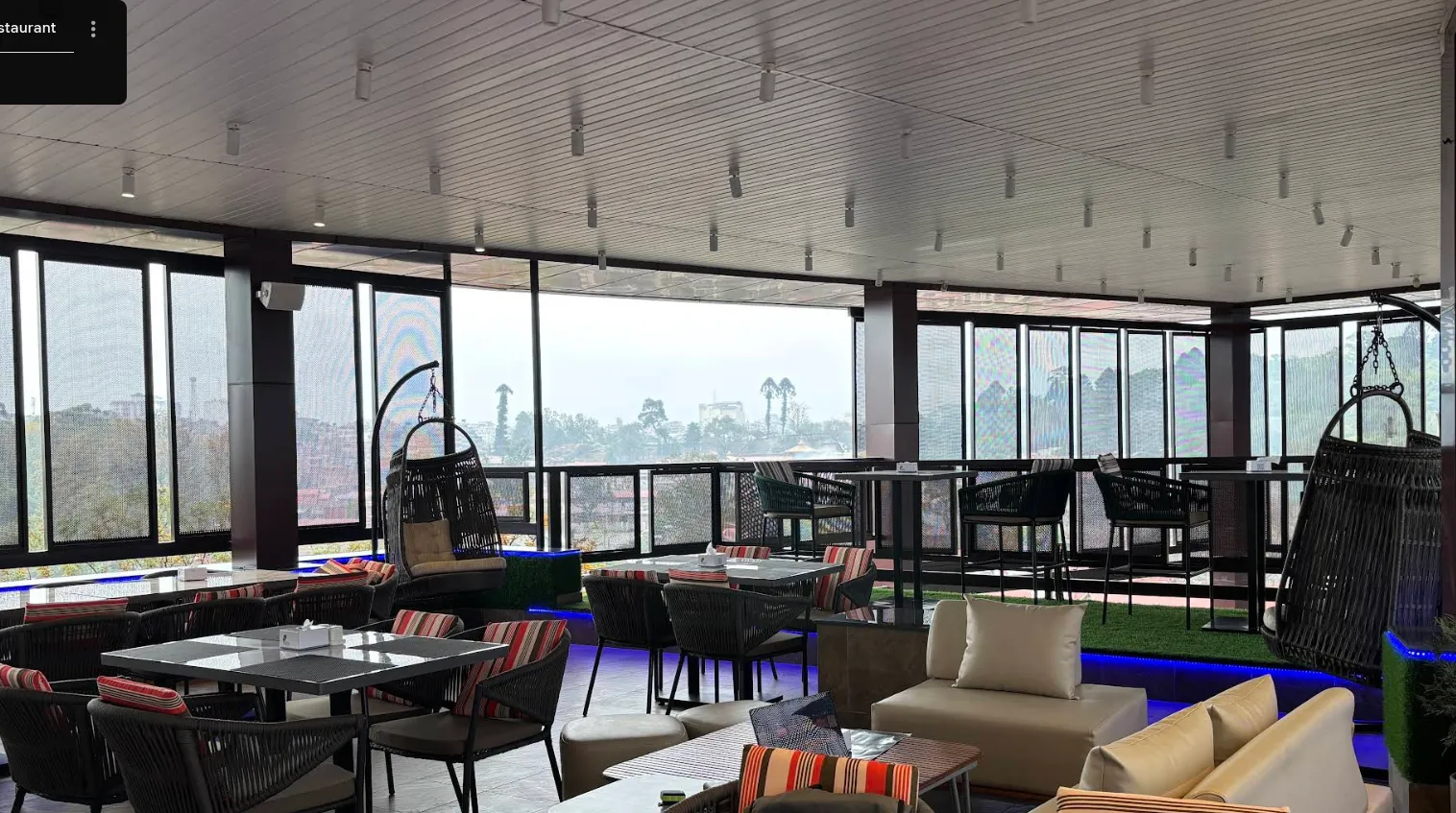 The Aura rooftop dining room with panoramic glass walls overlooking the Kathmandu valley